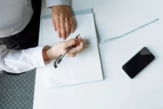 adult child organizing funeral documents and welfare checklist with phone nearby