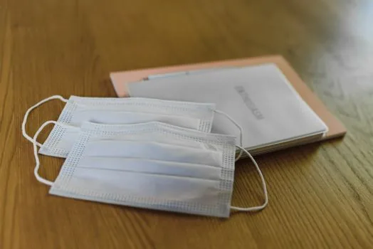 close up of Korean medical receipt, prescription paper, and bankbook copy on a calm wooden table, no personal data visible, realistic editorial photo