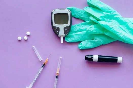 diabetes test strip boxes, lancets and insulin pen needles arranged beside Korean medical receipt and calendar