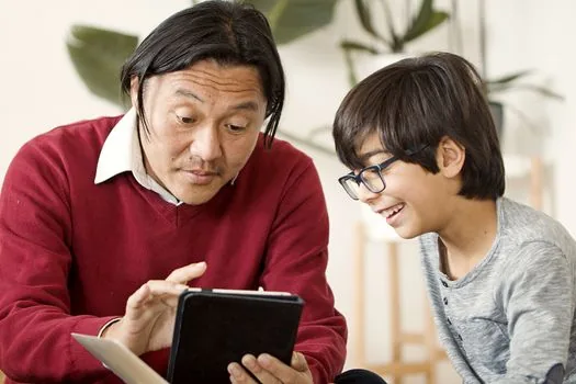 Elderly parent and adult child checking Government24 civil service page on tablet with checklist and reading glasses, realistic warm editorial photo | 정부24 민원 확인 | 신청방법·처리기간·대리 신청 제한을 먼저 보는 장면