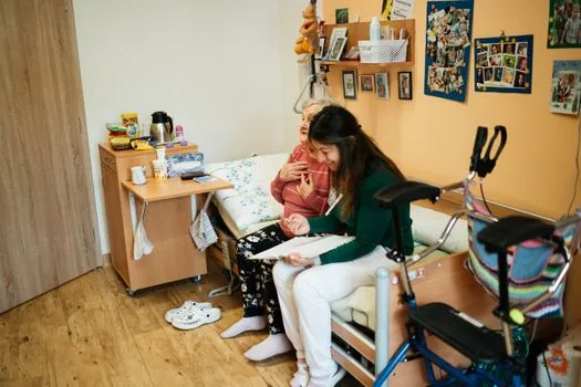 Korean caregiver arranging home care schedule, meal delivery note and clinic appointment calendar for senior parent, warm realistic photo