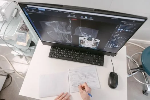 Korean elderly parent and adult child checking dental X-ray and denture consultation note at clinic desk, realistic healthcare editorial photo, no readable personal data | 치과 상담 전 완전틀니와 부분틀니 조건을 확인하는 장면