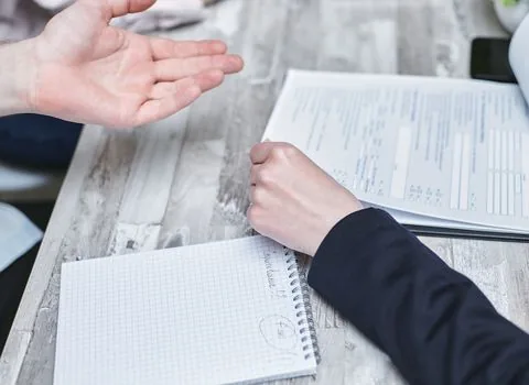 Korean family at local welfare office consultation desk reviewing home visit care eligibility with public officer, realistic document scene | 행정복지센터 상담 전 중복 서비스 확인