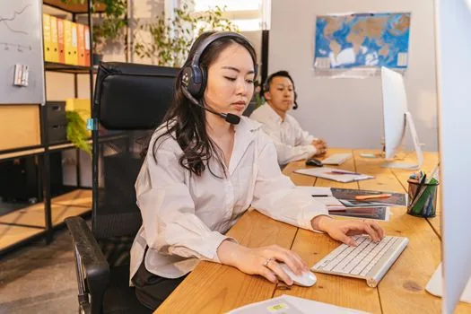 Korean family calling NHIS customer center while reviewing long term care recognition certificate and service invoice, realistic bright office photo