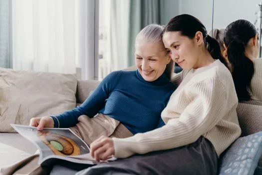 Korean family checking disability welfare card, income eligibility memo and online welfare application checklist with elderly parent at home, realistic warm photo | 가족이 장애수당 신청 자격을 확인하는 장면