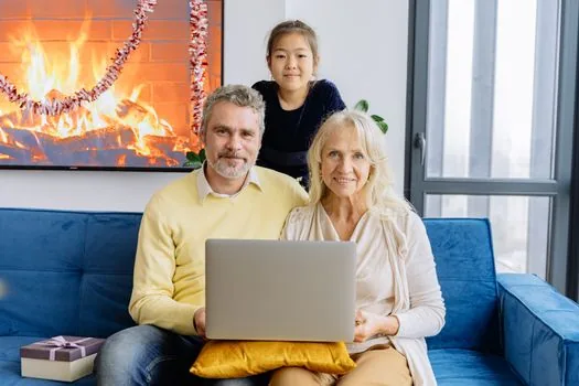 Korean senior and adult child searching local senior job listings on laptop at home table