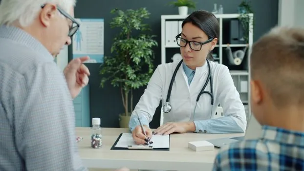 Korean sleep clinic consultation with CPAP usage report, prescription form and adult child taking notes beside senior parent