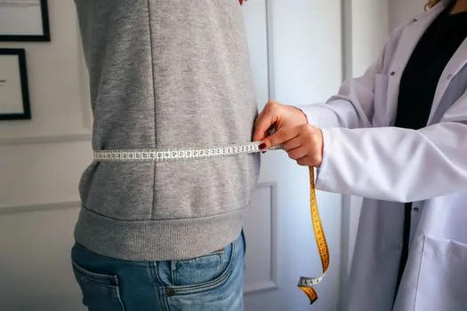 Senior apartment window insulation inspection with adult child holding checklist and tape measure