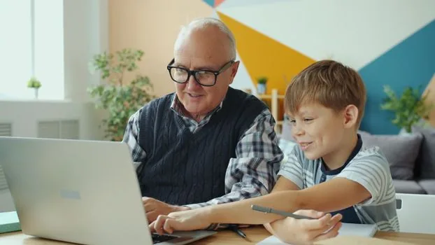 senior parent and adult child checking health screening eligibility on laptop with paper calendar and reading glasses
