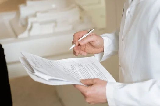 senior patient discharge checklist, home address note and caregiver schedule on hospital table, realistic Korean welfare photo