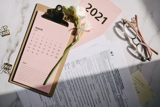 senior welfare center bulletin board with program timetable, class registration notice and reading glasses, realistic Korean community facility photo | 프로그램 접수 일정 확인 | 회원가입 뒤 별도 모집 기간과 정원을 확인하는 장면