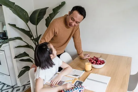 adult child and elderly parent checking welfare application form and phone number at kitchen table, bright Korean home, realistic photo | 응급안전안심서비스 신청 전 가족 상담 장면