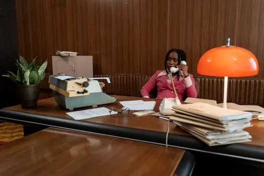 adult child calling local administrative welfare center with funeral documents and calendar deadline marked, realistic warm office home photo | 주소지 행정복지센터에 신청 가능 여부를 문의하는 장면