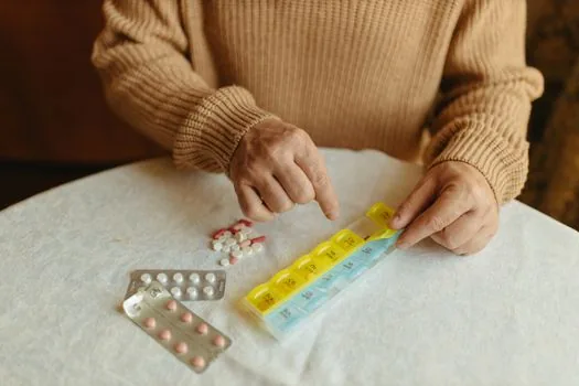 adult child sorting dementia prescription receipt and bankbook copy on kitchen table for elderly parent, realistic Korean home