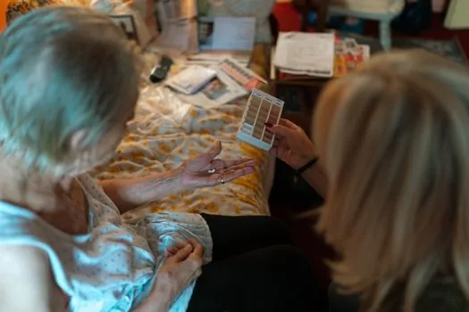 caregiver checking prescription diagnosis code and pharmacy receipt with dementia care center checklist, realistic paperwork closeup