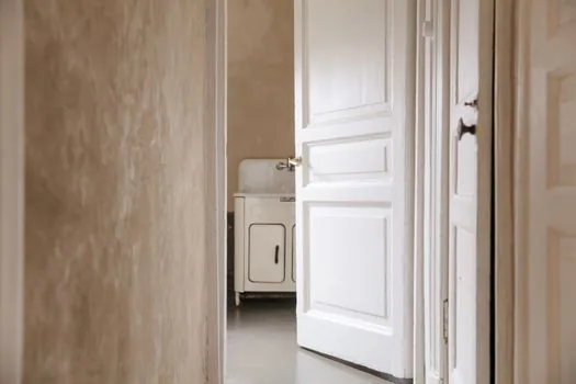 caregiver measuring apartment elevator path before old washing machine pickup, realistic Korean apartment hallway photo | 세탁기 수거 전 엘리베이터와 현관 동선을 확인하는 장면