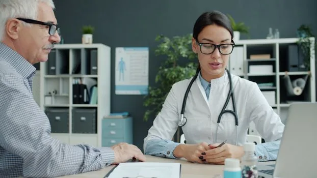 elderly parent and adult child reviewing vaccination consent form with doctor in bright Korean clinic consultation room | 의료진과 접종 전 예진 내용을 확인하는 장면