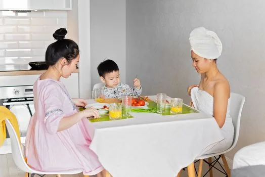 Korean adult child organizing parent long-term care grade certificate hospital admission note and phone numbers on kitchen table, realistic editorial photo | 보호자가 장기요양 인정서와 요양병원 입원 메모, 연락처를 정리하는 장면