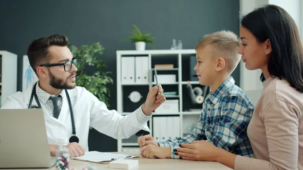 Korean community service center consultation desk with adult child asking about emergency care application for elderly parent, realistic public office