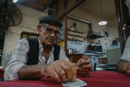 Korean elderly parent and adult child checking ID card and transit card application at local community center counter, realistic bright photo | 어르신 교통카드 신청 전 신분증과 접수처를 확인하는 장면