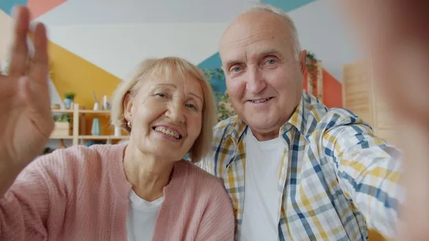 Korean family calling forest recreation facility before booking with voucher note and travel calendar, calm living room, realistic senior editorial photo | 산림복지시설 예약 전 이용권 결제 가능 여부를 전화로 확인하는 장면