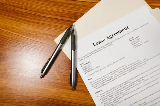 Korean family checking jeonse lease contract, calendar with moving date, apartment documents on wooden table, bright realistic photo