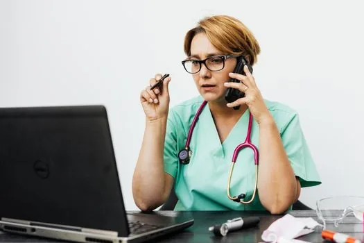 Korean family member calling nursing hospital administration while checking parent admission papers and caregiving cost memo, bright desk, realistic editorial photo | 보호자가 부모님 입원 서류와 간병비 메모를 보며 요양병원 원무과에 확인하는 장면