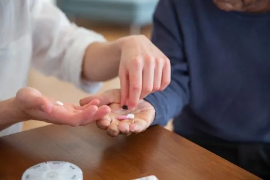 Korean family organizing dementia care notes, long term care application status, medication list and center phone number on warm home table, realistic senior care photo | 치매환자쉼터 상담 전에 가족이 질문을 정리하는 장면
