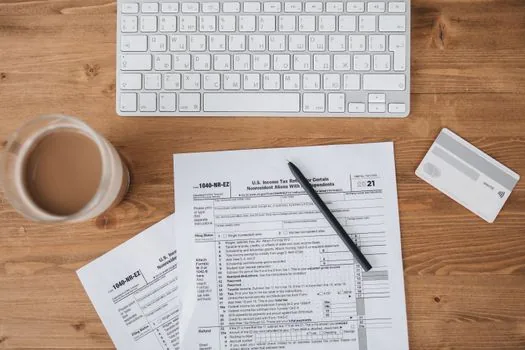 Korean national pension branch consultation desk with claim form ID card bankbook and family documents arranged neatly, realistic public office photo | 분할연금 청구서류를 공단 상담 전 정리하는 장면