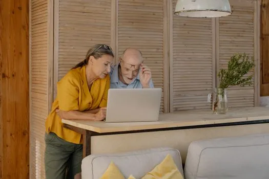Korean senior family checking online fitness assessment reservation calendar with glasses and memo | 국민체력100 예약 달력과 오픈 시간을 확인하는 장면