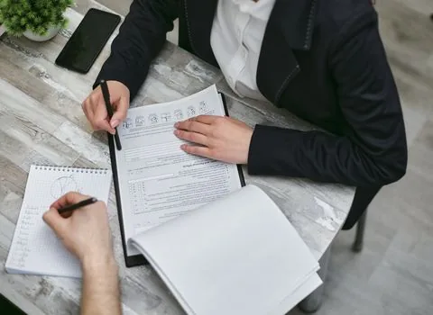 passport, overseas moving checklist, national pension forms and bank account document arranged on a bright desk | 국외이주 반환일시금 서류를 확인하는 장면