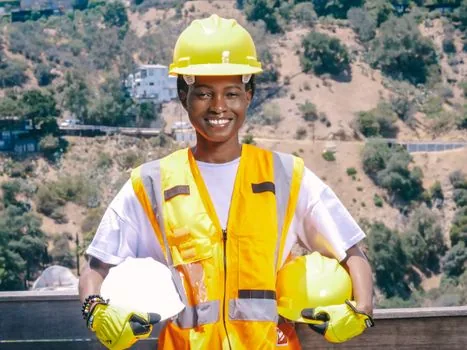 reflective safety vest gloves and simple checklist beside recycling cart | 폐지수집 안전과 상담 메모를 함께 확인하는 장면
